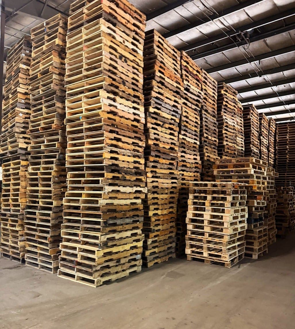 Stacks of inspected recycled wood pallets ready for shipment